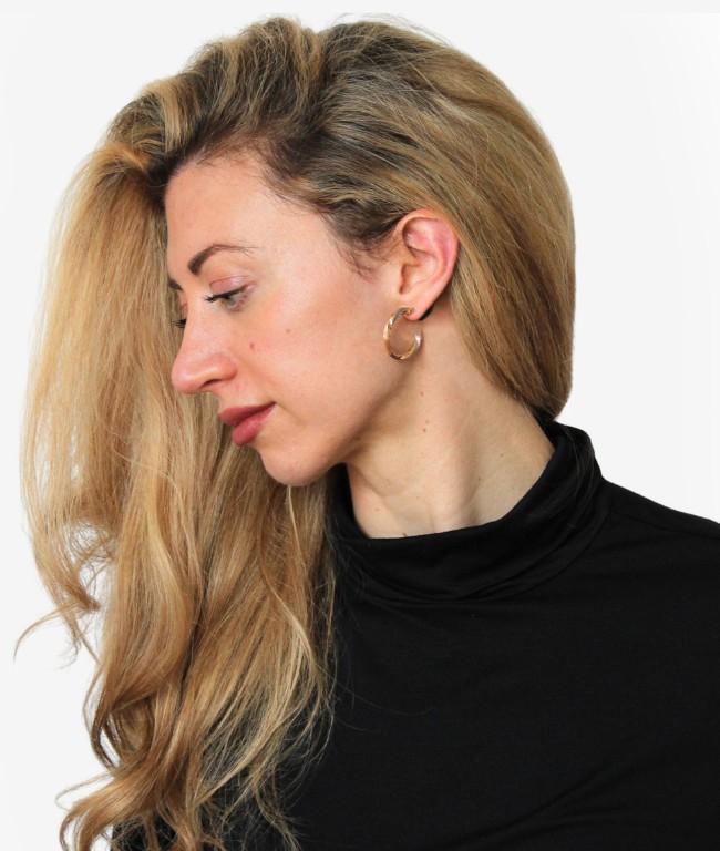 Phira wearable worn behind the ear, close up
